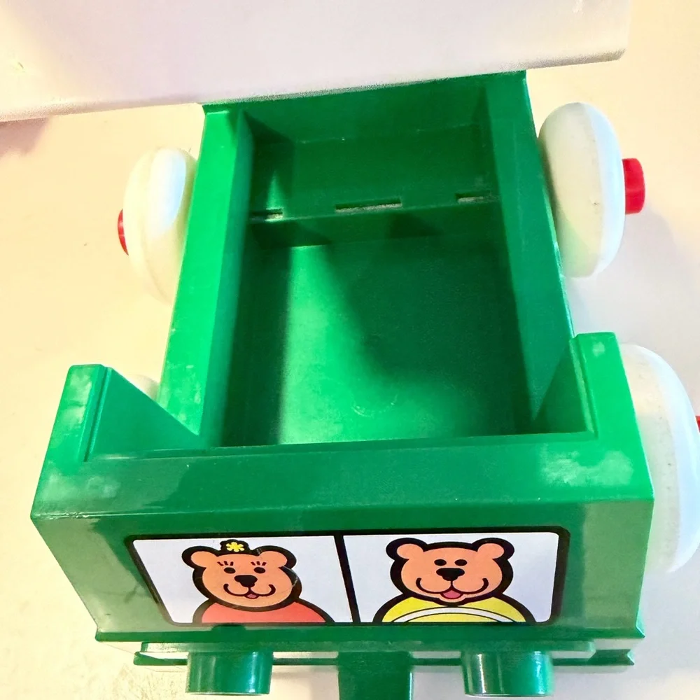 Johnson and Johnson vintage stacking rings pull string truck toy with person
